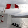 29-the-peru-flag-flying-from-the-stern-of-the-ship-with-the-city-of-puno-in-the-background