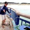 28-a-crab-fisherman-gets-ready-to-throw-his-baited-net-over-the-railing