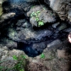 30-kacey-looking-down-into-an-old-lava-tube